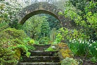 View up steps to circular brick-built entrance and garden beyond. Greencombe Garden, Porlock, Somerset, UK. 
