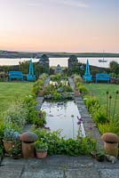 Dawn breaks over the coastal garden at Quoy of Houton, Orkney, unveiling an 18-metre-long rill edged in flag irises, alchemilla, libertia, allium and grasses.