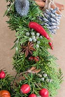 Star anise with conifer, yew and rosemary, red chillies and rose hips.