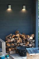 View of rustic wood pile in cosy garden shed area. 