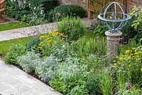 Armillary Sundial in mixed bed. Garden Design by Peter Reader Landscapes.
