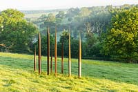 Metal sculpture in the form of standing stones, Plaz Metaxu Garden, Devon, UK. 