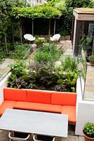 View of modern, multi-level garden with sunken seating area.

