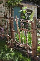 Driftwood Garden gate. 'A Postcard From Wales' Garden, RHS Chelsea Flower Show.