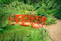 Red oriental bridge at Abbotsbury Gardens, Weymouth, Dorest, UK.