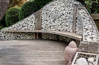 Gabion wall with a hardwood seating attached, with wood decking