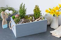Finished Easter box with decorative rabbits, miniature trees, bridge and well. 
