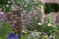 Contemporary planting set against a traditional Cotswold stone wall in Cotswold Connections, RHS Tatton Park Flower Show, 2016. 