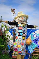 'My Space in Space', school garden scarecrow with patchwork coat made of 
children's drawing laminated and tied on with garden twine