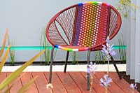 Brightly coloured bucket chair. 'Ocean Garden', designed by Michel Damien, RHS Malvern Spring Festival, 2017. 