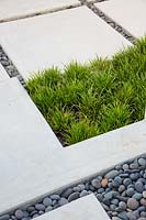View of paving, pebbles and grasses in modern garden. The Hammond Residence, Key West, Florida, USA.