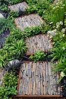 Rough stepping stones in the Through Your Eyes garden, designed by Lawerence Roberts and William Roobrouck, sponsored by Kebony, CED Stone Group, RandG Metal Products at RHS Hampton Court Garden Festival, 2019.
