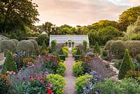 A fully restored Victorian walled kitchen garden is planted with a mix of topiary, annual flowers, herbs, fruits and vegetables.