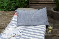 Close up of mattress  and pillow on wooden terrace 