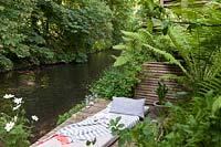 Secluded wooden decked terrace next to a creek 