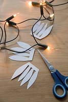 With scissors cut a freehand shape with 4 petals on it to make the base for the decorative bulb