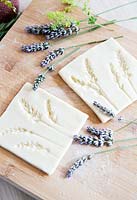 Salt dough cut into individual tile shapes decorated with lavender flower impressions