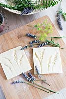 Salt dough with impressions of lavender flowers pressed into individual tile shapes 