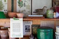Garden Cottage at Gunwalloe in Cornwall. Cottage garden in autumn. The potting shed interior wall with information.