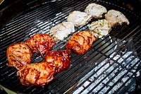 Green oasis garden in West London - chicken cooking on barbecue.