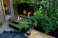 Dining table and benches in urban, multi-level contemporary garden
