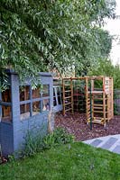 Contemporary garden in Wimbledon - with children's play area with climbing frame and shed.