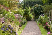 The main herbaceous borders at Wollerton Old Hall Garden, near Market Drayton, Shropshire. Planting includes: Agapanthus, Dahlias, Phlox, Salvias jamensis and Heuchera.