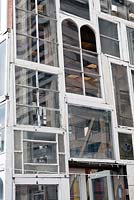 Recycled sash windows that make up the giant glasshouse lantern at the Skip Garden, Kings Cross, London, UK.
