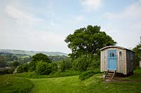 View to countryside with shepherds hut at Wild Meadows.