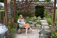 Emily Barnes, Designer, sitting in her 'Elements of Sheffield' garden at the RHS Chatsworth Flower Show 2019.