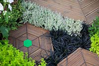 Hexagonal decking bordered with herbs in 'This Wild Life Garden' at BBC Gardener's World Live 2018.