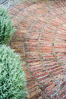 Radial brick paving in formal herb garden