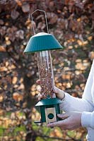 Feeding the birds with a squirrel proof bird feeder. 