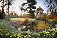 Temple of the Four Winds surrounded by naturalised daffodils and the bright stems of cornus and willow at Doddington Hall, Lincolnshire.