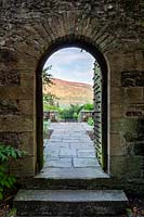 View through doorway to Simon's Seat at Parcevall Hall Gardens, Yorkshire, UK. 