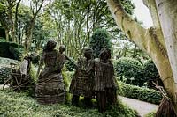 wicker people family by Agnieszka Gradzik and Wiktor Szostalo covered in Muehlenbeckia compactus. Les Jardins d'Etretat, Normandy, France
