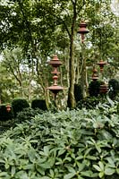 Terracotta sculptures hanging from trees by Sergei Katran in the Jardin Zin. Les Jardins d Etretat, Normandy, France