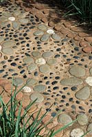 Decorative concrete path with embeded pebbles and stones 
