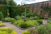 The Herb Garden. A small, formal, walled space planted with herbs, annuals, box topiary and roses. Arley Hall, Cheshire, UK.
