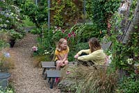 Victoria and her daughter chatting in the gravel garden.
