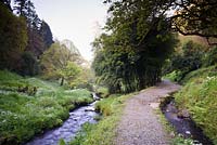 The Edgcumbe Stream tumbles through the garden between banks.