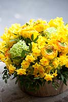 Floral arrangement using daffodils, Ranunculus and Guelder rose. 