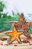 Scented decorations made from metal cookie cutters filled with orange peel and cinnamon sticks