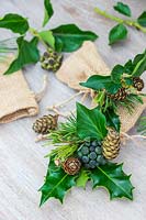 Small table favours. Small hessian bags filled with foliage, Ivy berries and cones