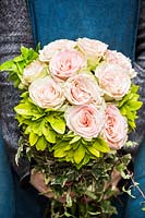 Bouquet of fragrant choysia ternata leaves, roses and ivy branches. 