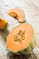 Melon 'Retato' cut open to show skin, flesh and seeds