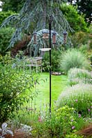 Bird feeder with feeders for nuts, seeds and fat balls