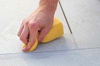 Using a sponge to clean freshly grouted context Porcelain patio
