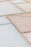Close up detail of riven sandstone paving in 'Country Green' colour scheme