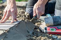 Man using trowel to smooth and finish cement edge
